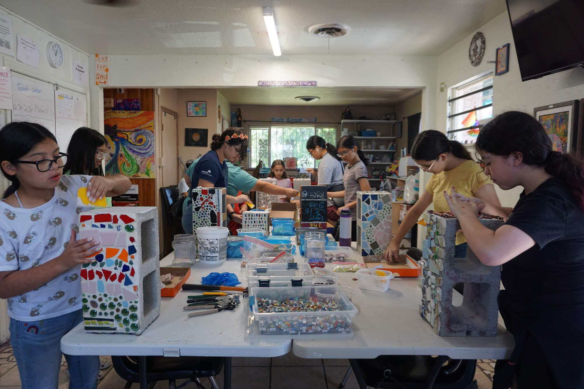 Children artistically decorating cinder blocks